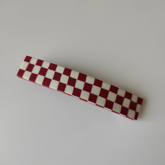 Red and bone checkerboard pin